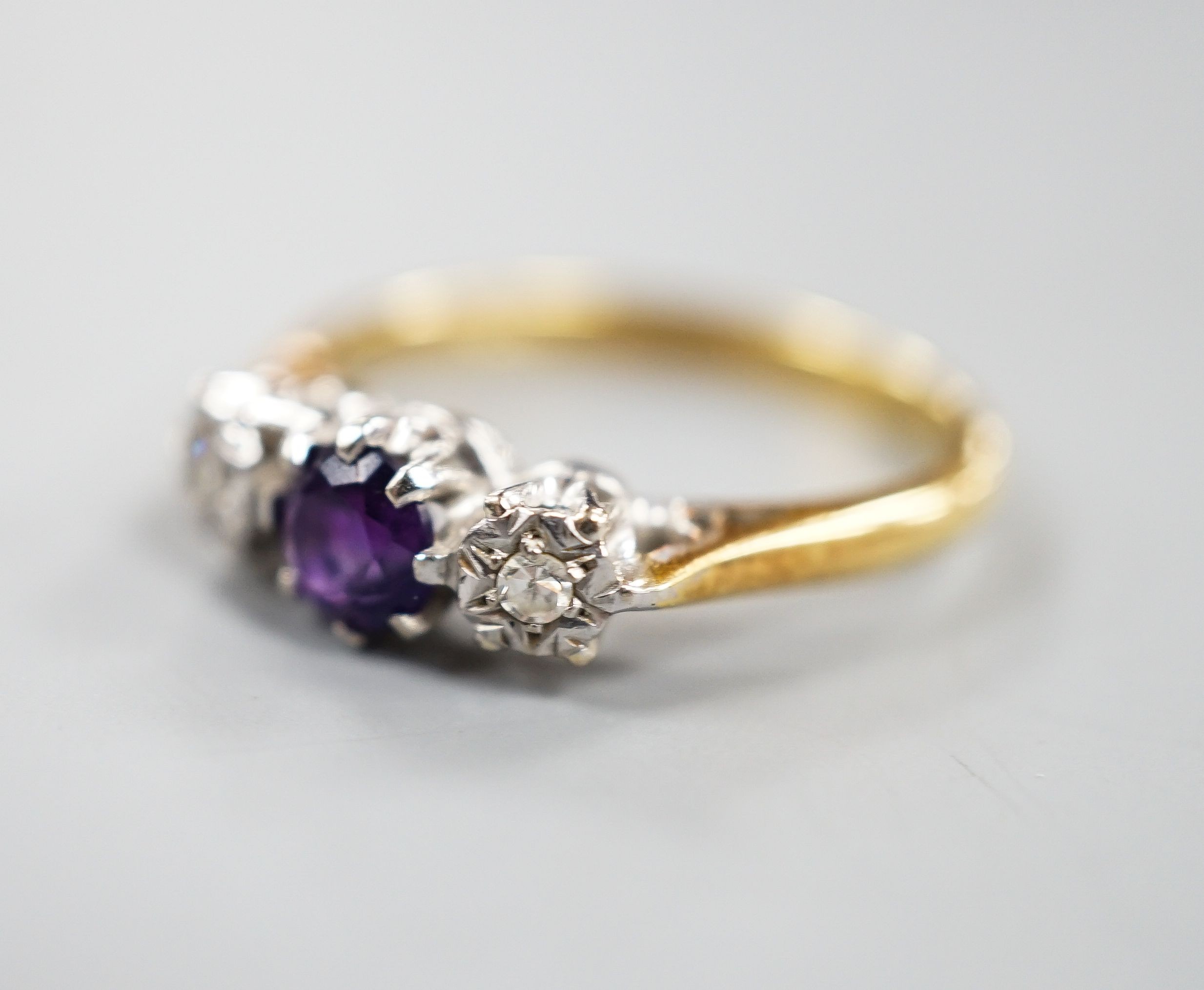 An 18ct, singe stone amethyst and illusion set two stone diamond ring, size, O/P, gross weight 3.7 grams.
